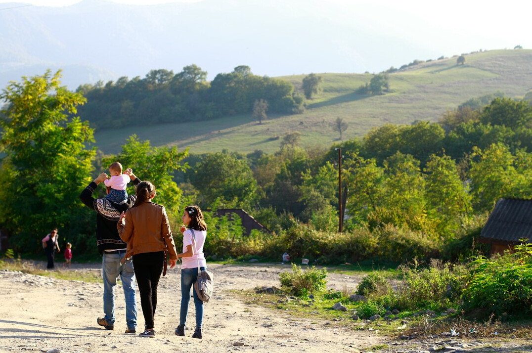 Happy family of three walking outdoors together